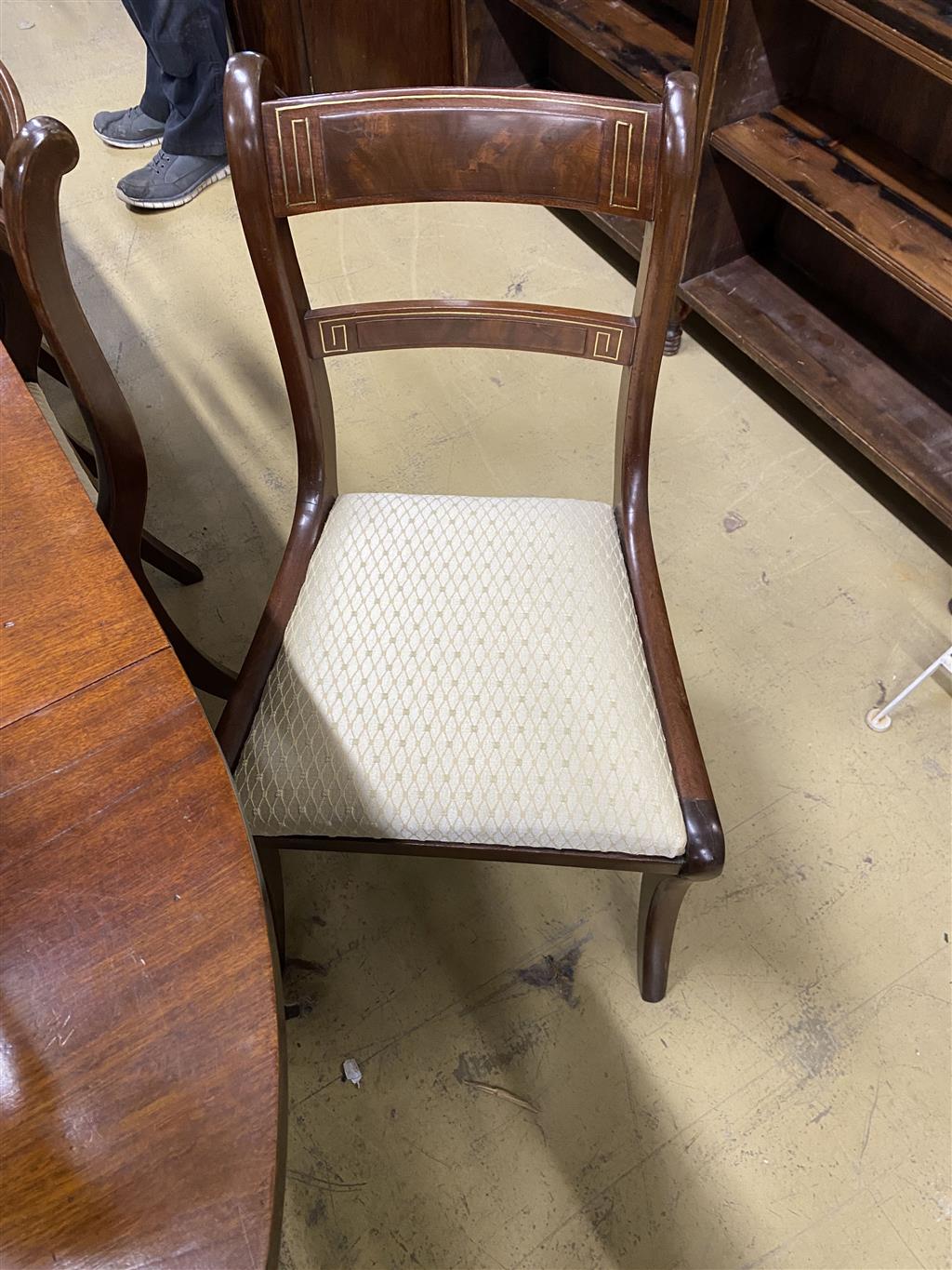 A set of eight Regency mahogany brass inlaid dining chairs, on sabre legs and a similar elbow chair